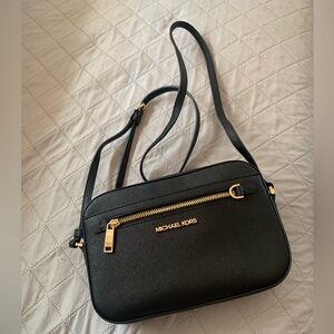 Michael Kors black cross body purse, small to medium size.